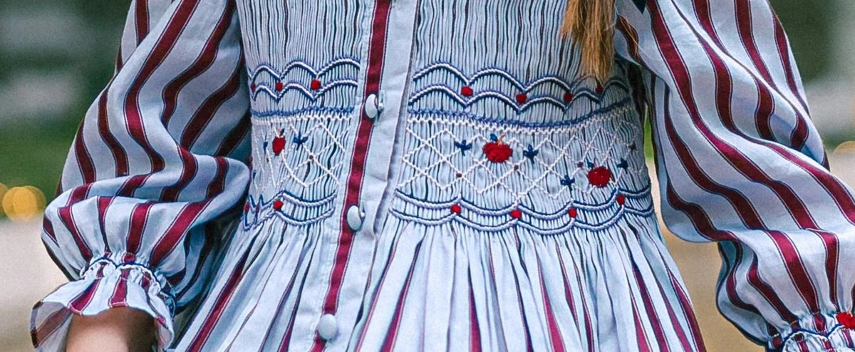 Blue and burgundy striped smocked dress with apple embroidery