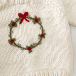 Child in the cream Wreath Sweater with embroidered wreath and red berries