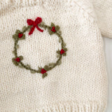 Child in the cream Wreath Sweater with embroidered wreath and red berries