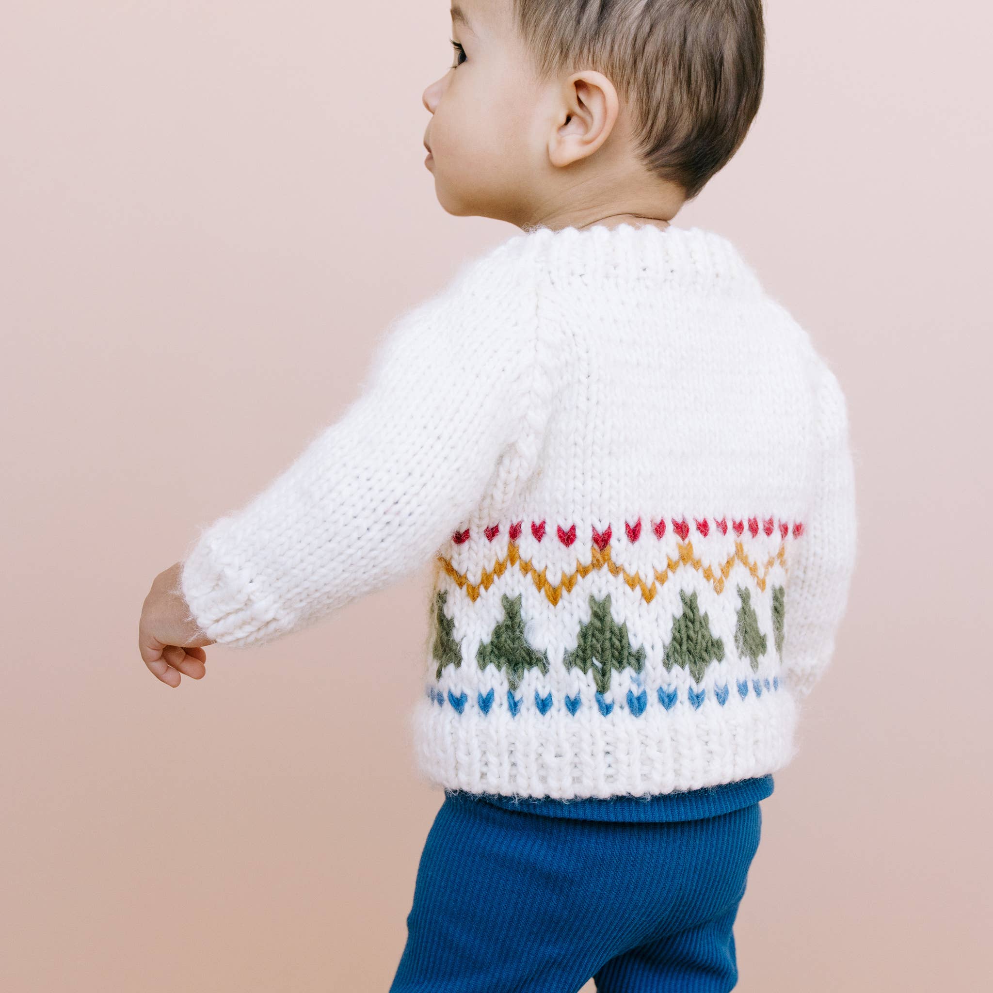 Child wearing the Tree Fair Isle Cardigan for holiday photos