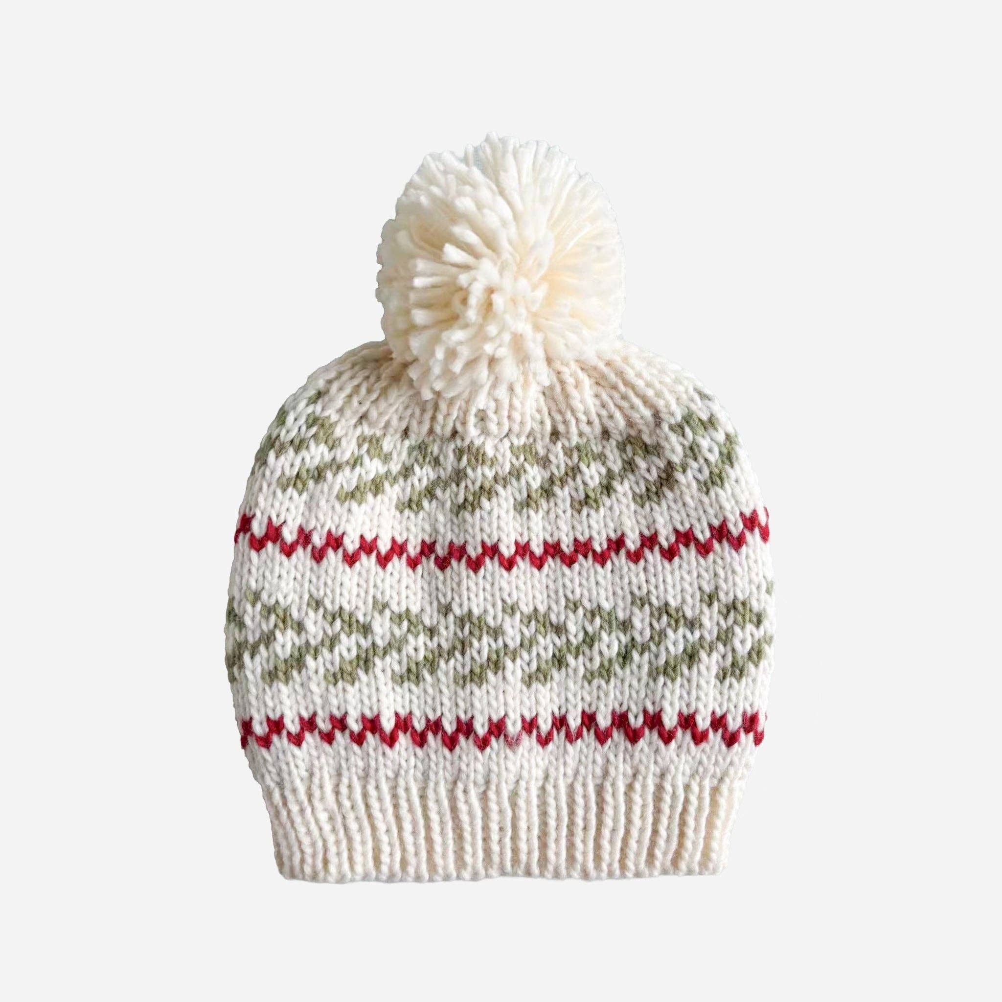 The Blueberry Hill Evergreen hand-knit baby hat in cream with moss green pine sprigs and red stripes