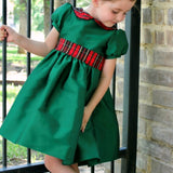 Girl wearing Susanne Lively green taffeta dress with plaid collar and sash