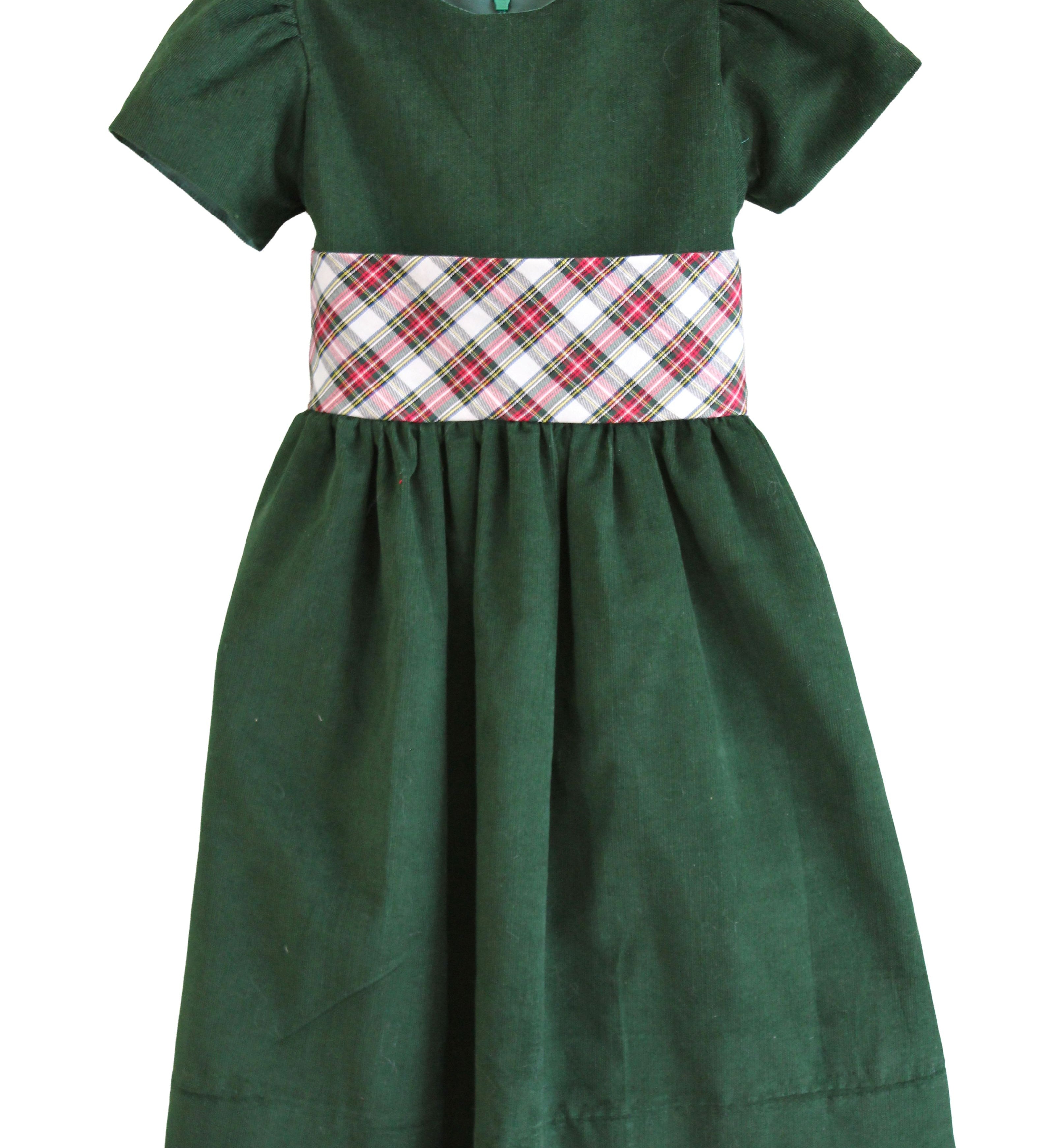 Susanne Lively hunter green corduroy dress with puff sleeves and a wide ivory tartan sash at the waist