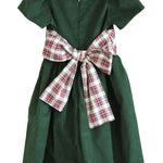 Back of the Susanne Lively green corduroy dress with the ivory tartan sash tied in a large bow