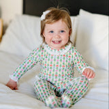 Baby wearing the Lucy romper in Tree Topper Bows