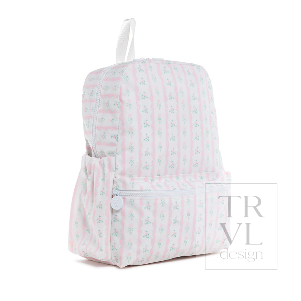 TRVL Backpacker kids' backpack in Ribbon Floral Pink, a pink ribbon floral coated cotton school backpack with a front zip pocket, shown from another angle