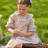 Girl wearing the Little English Smocked Molly Skirt in Durham Windowpane with the coordinating Bespoke Blouse