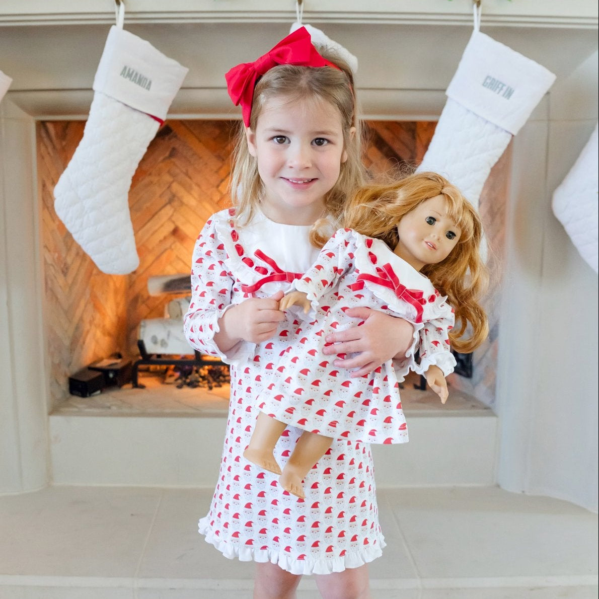 Girl and doll in matching Whimsical Santa Emersyn dresses