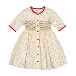 Hand-smocked holly and berry detail on the Antoinette Paris Elysée Christmas dress