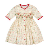 Hand-smocked holly and berry detail on the Antoinette Paris Elysée Christmas dress