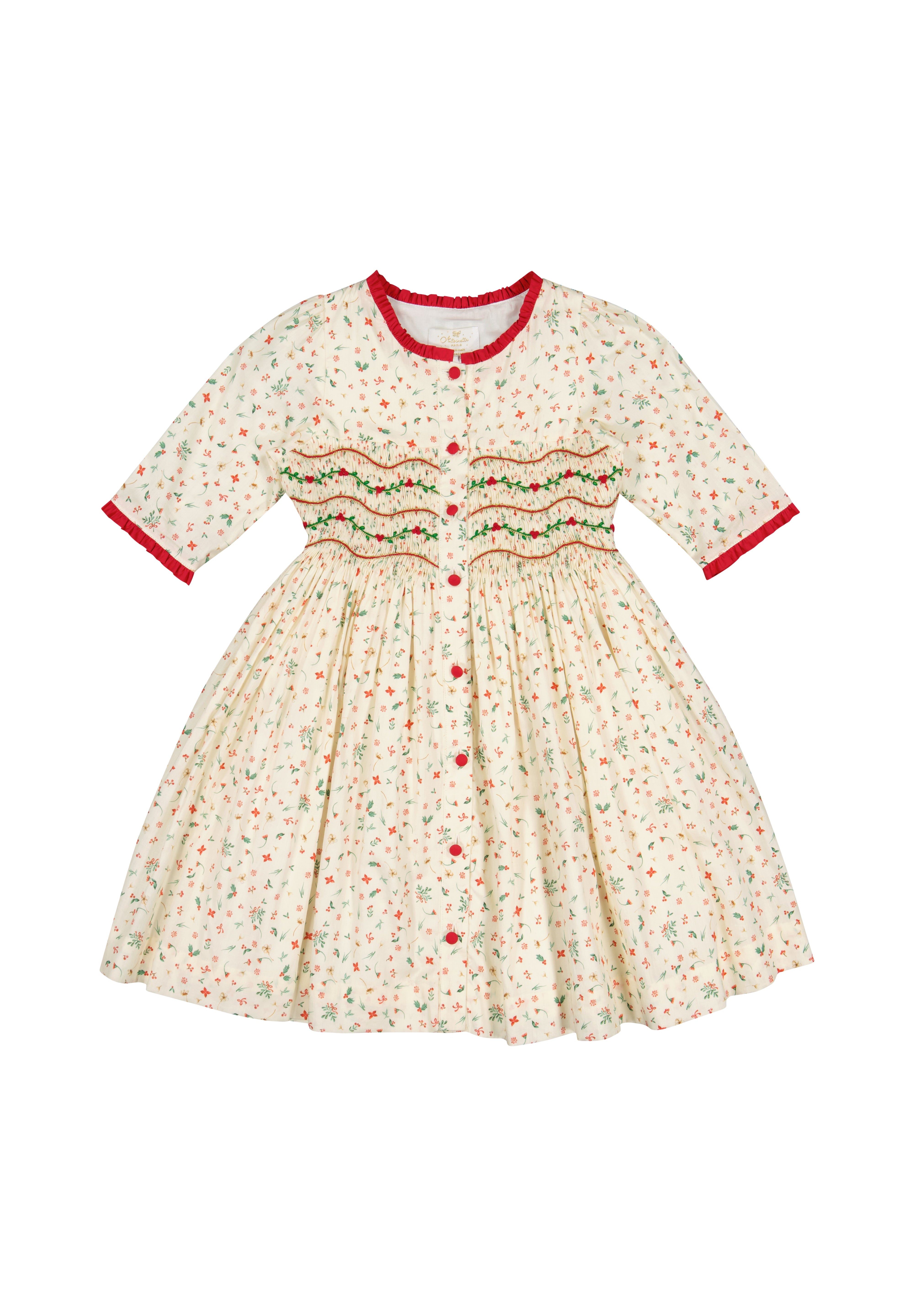 Hand-smocked holly and berry detail on the Antoinette Paris Elysée Christmas dress