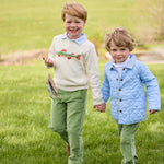 Boy wearing Little English Intarsia Sweater in Brook Trout layered over a Long Sleeve Polo in Light Blue Stripe with Watercress Corduroy Pull On Pants
