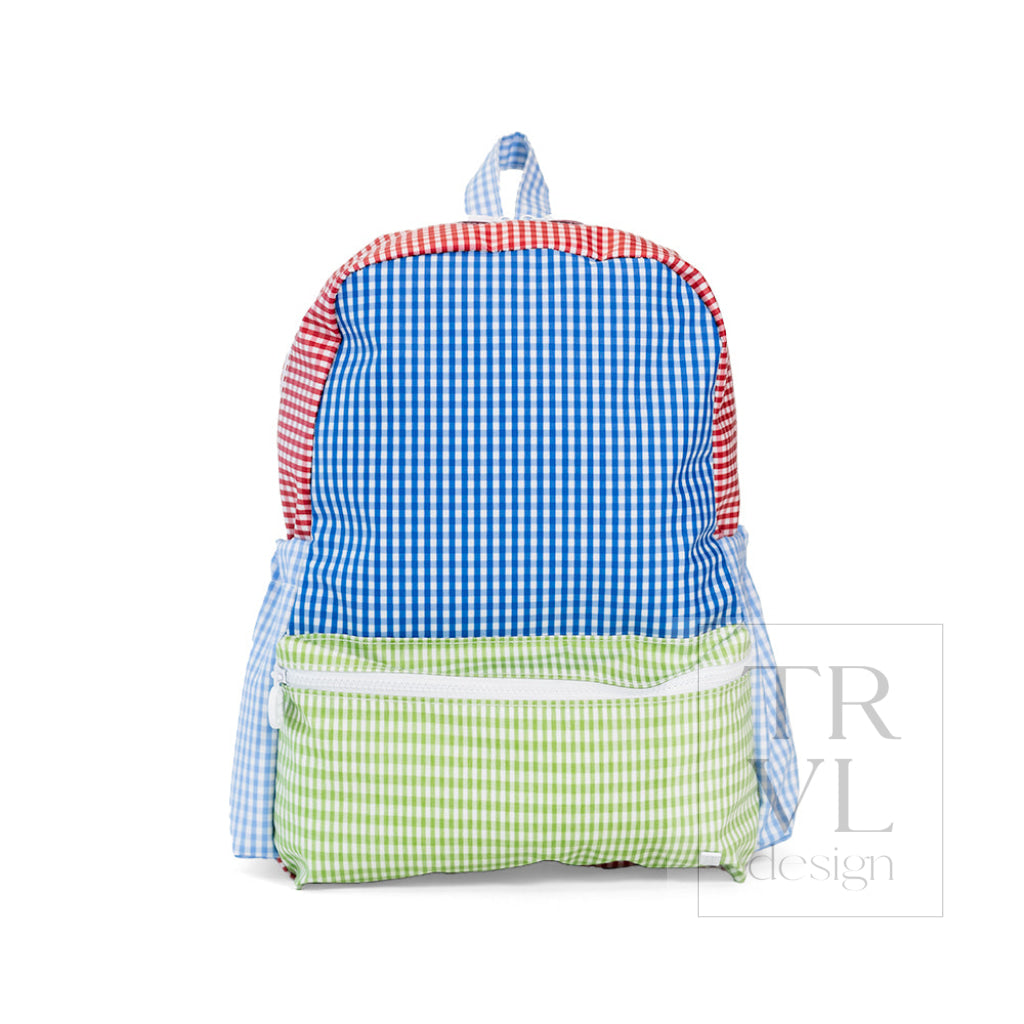 TRVL Backpacker kids' backpack in Patch Blue, a blue patchwork print coated cotton school backpack with a front zip pocket