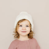 Baby wearing the cream Classic Pom Hat
