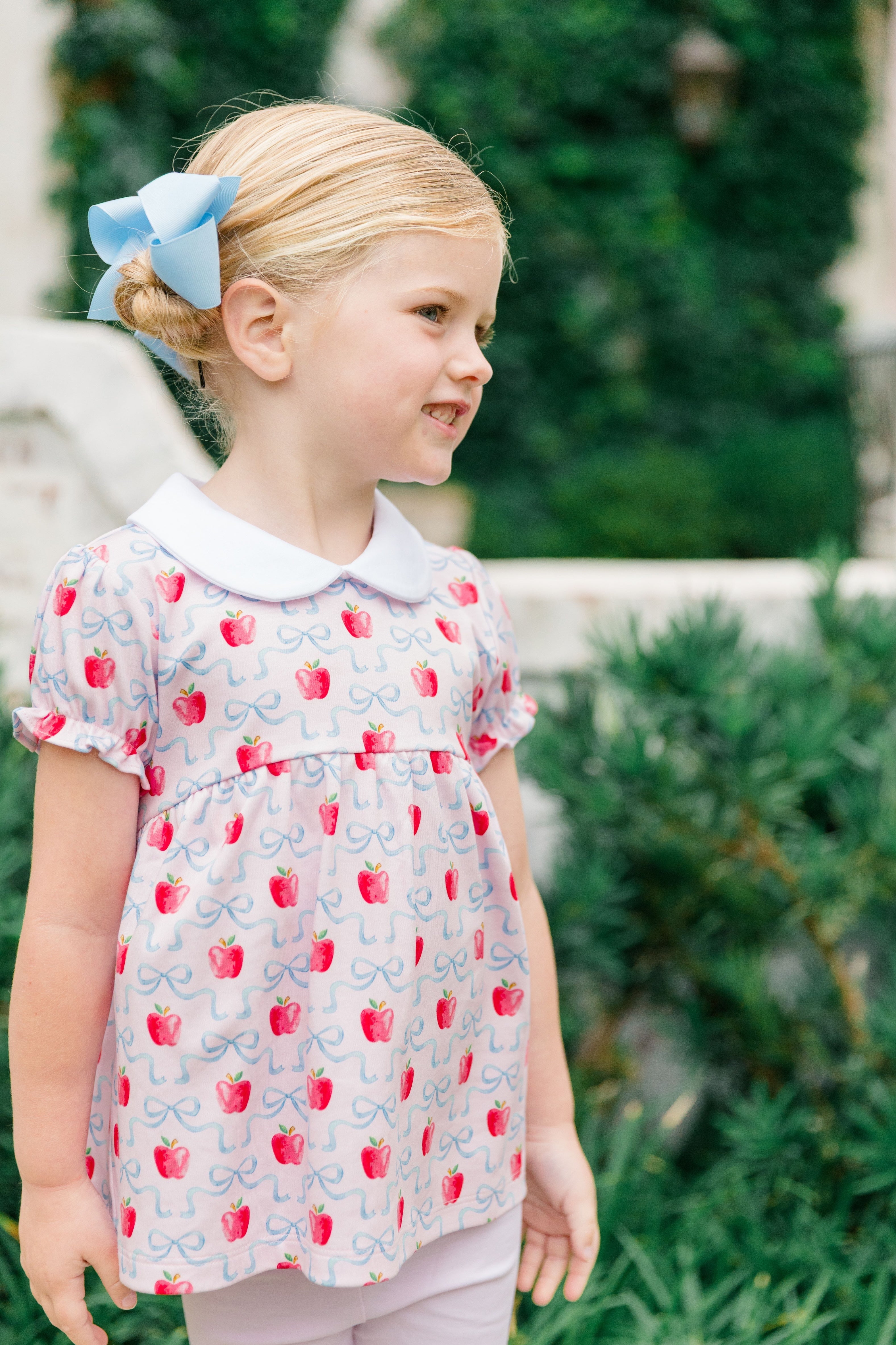 Girl wearing The Proper Peony Apple Blossom tunic set